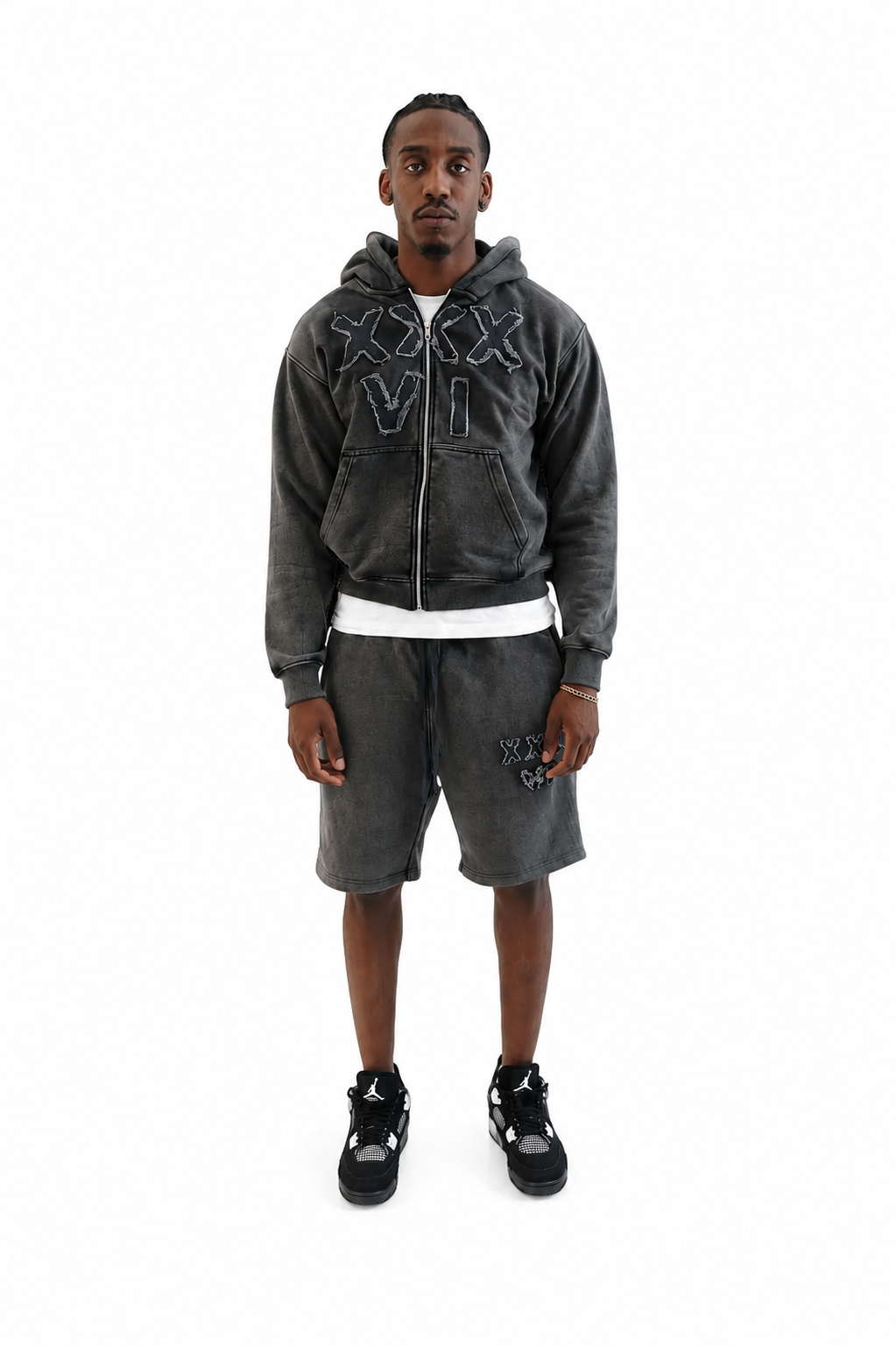 Man wearing acid wash gray hoodie and shorts with embroidered distressed designs on a white background